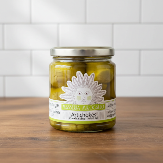 Masseria Mirogallo Artichokes in Extra Virgin Olive Oil sobre mesa de madera con pared de azulejos blancos